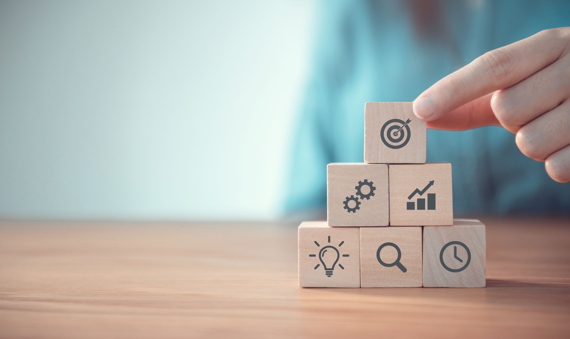 Businessman hand arranging wood block with icon business strategy and Action plan, copy space.